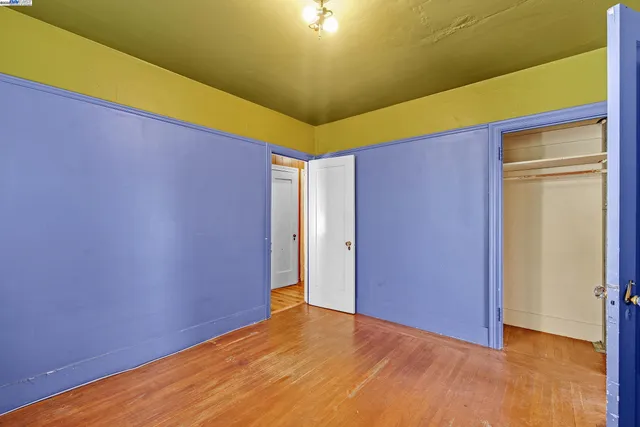 a view of a room with window and wooden floor