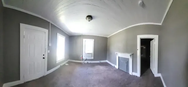 a view of a hallway with bathroom and window