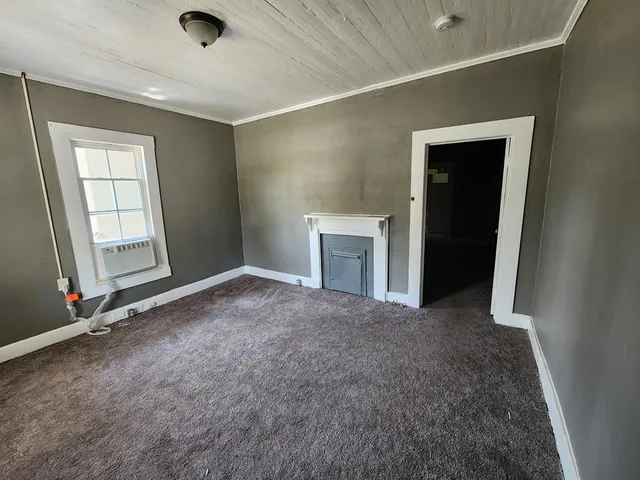 an empty room with windows and closet