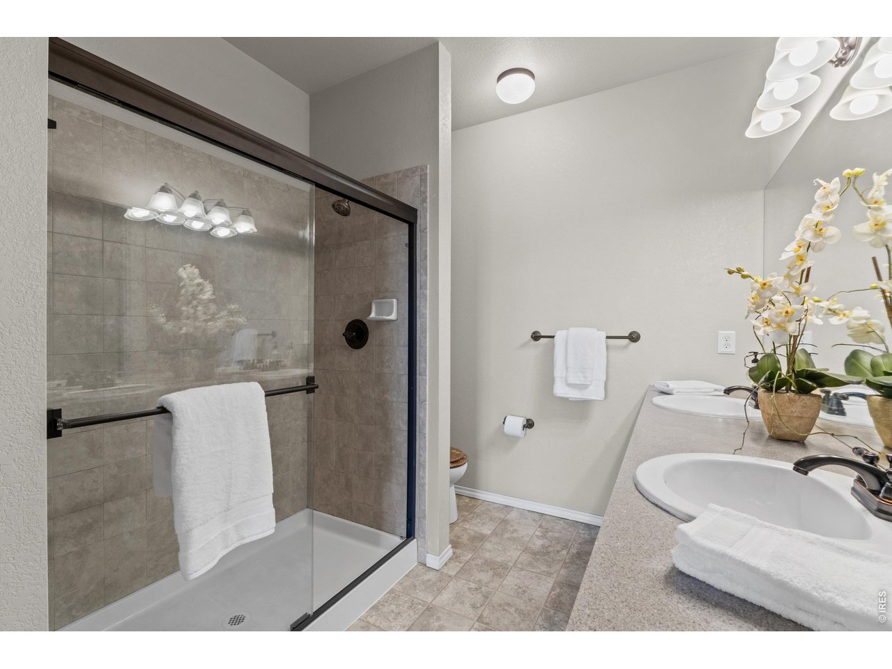6911 West 3rd Street, Unit 810 Greeley, CO 80634 - Photo 15 of 28 a bathroom with a sink a toilet and shower