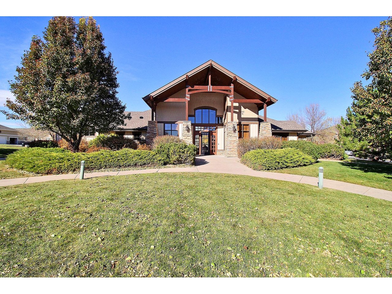 6911 West 3rd Street, Unit 810 Greeley, CO 80634 - Photo 23 of 28 a front view of a house with a yard