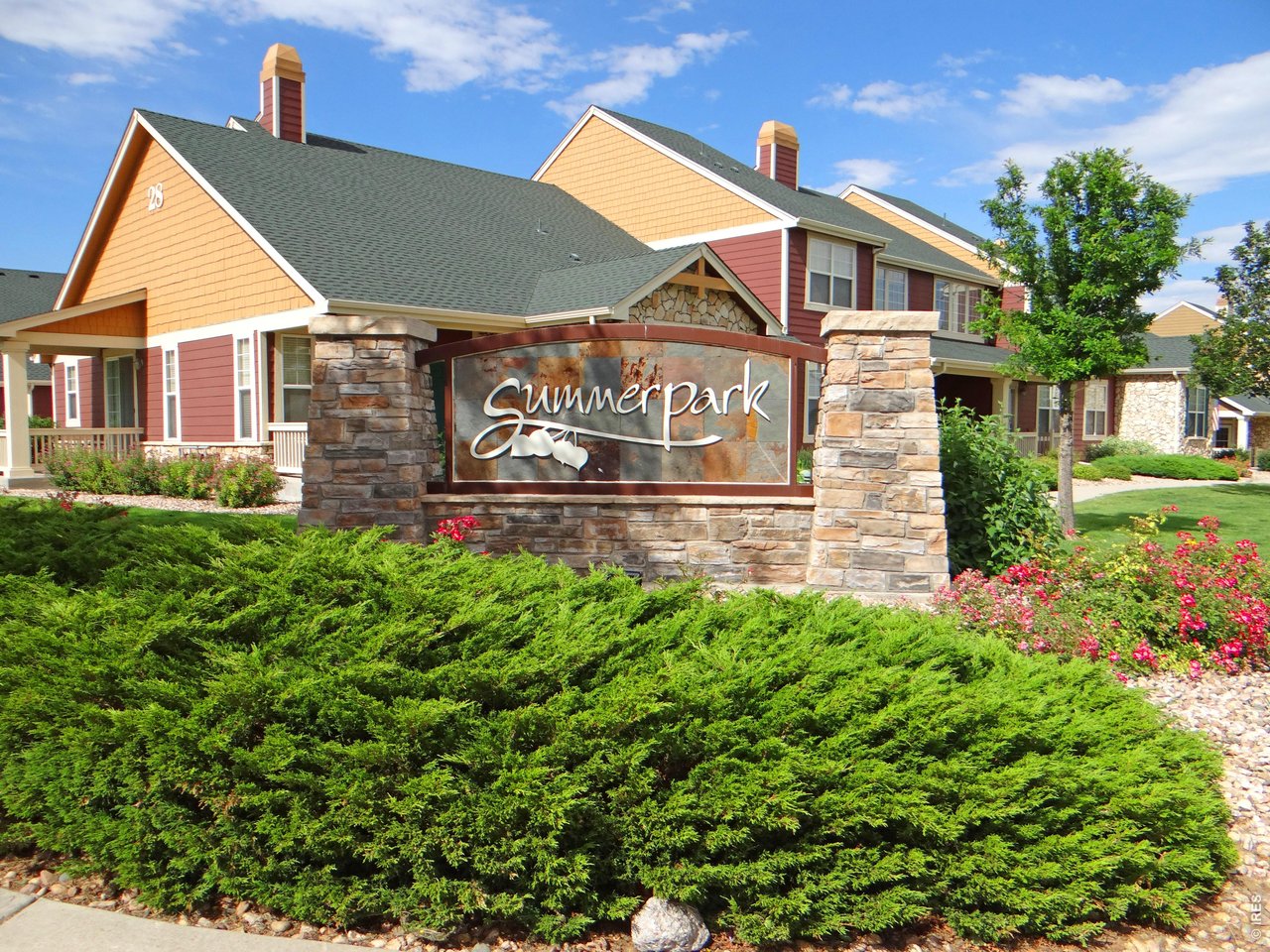 6911 West 3rd Street, Unit 810 Greeley, CO 80634 - Photo 24 of 28 a view of a house with a yard and plants