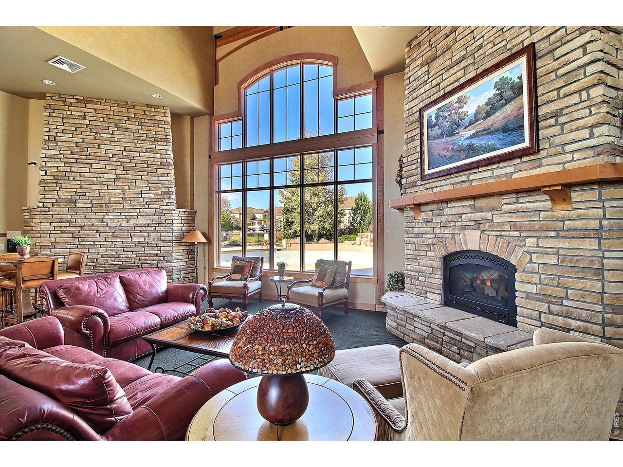 6911 West 3rd Street, Unit 810 Greeley, CO 80634 - Photo 25 of 28 a living room with furniture a fireplace and a floor to ceiling window