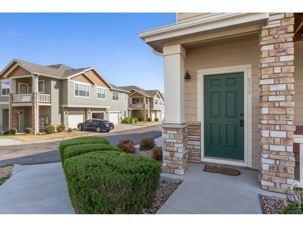 6911 West 3rd Street, Unit 810 Greeley, CO 80634 - Photo 3 of 28 a front view of a house with a garden and plants