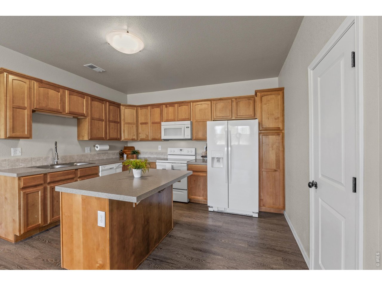 6911 West 3rd Street, Unit 810 Greeley, CO 80634 - Photo 9 of 28 a kitchen with stainless steel appliances granite countertop a sink stove and refrigerator