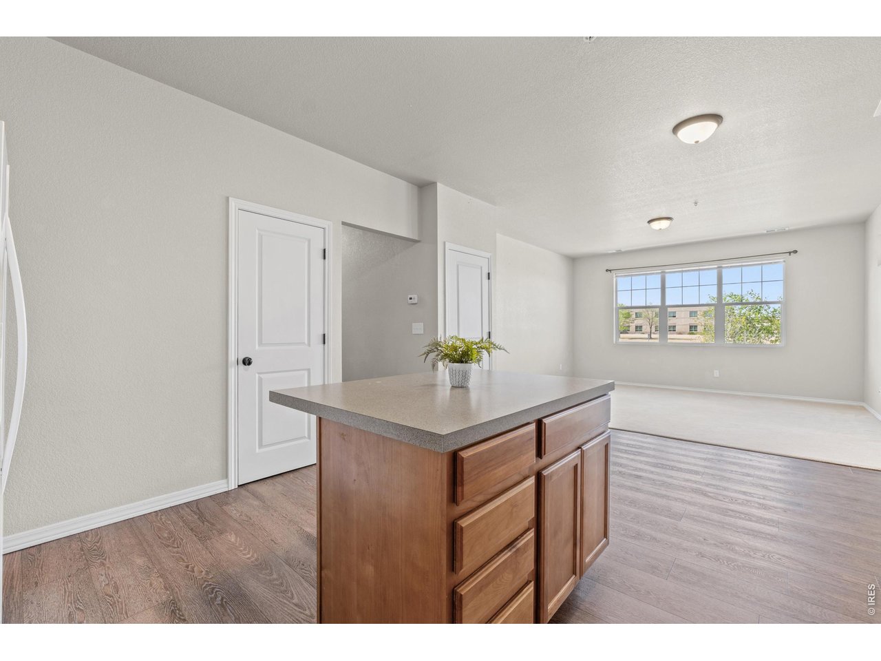 6911 West 3rd Street, Unit 810 Greeley, CO 80634 - Photo 10 of 28 a kitchen with stainless steel appliances granite countertop a stove cabinets and wooden floor