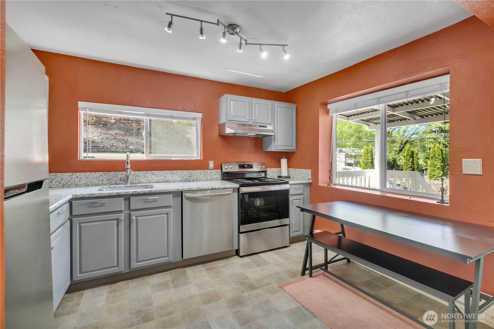 2307 Southwest Myrtle Street Seattle, WA 98106 - Photo 11 of 30 a kitchen with stainless steel appliances granite countertop a stove a sink and a microwave