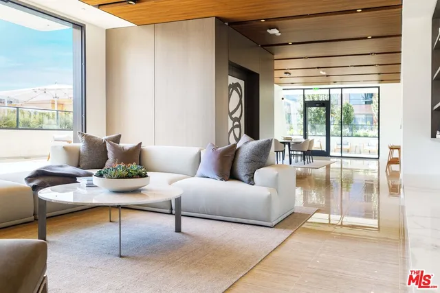 a living room with furniture and a floor to ceiling window