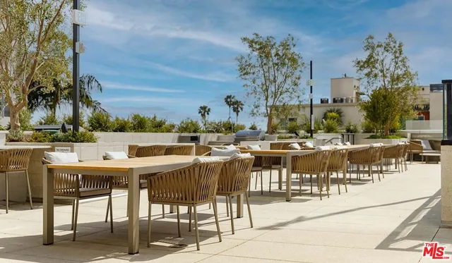 a view of a patio with dining table and chairs