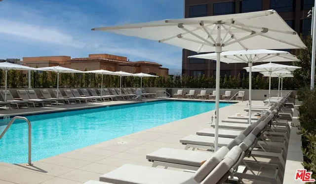 an aerial view of a house with swimming pool and outdoor seating