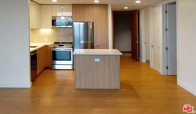 a kitchen with stainless steel appliances a refrigerator and a stove