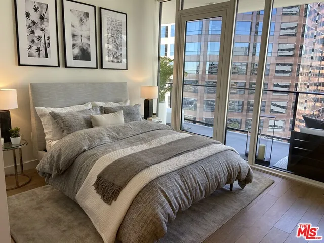 a bedroom with a large bed and a flat tv screen