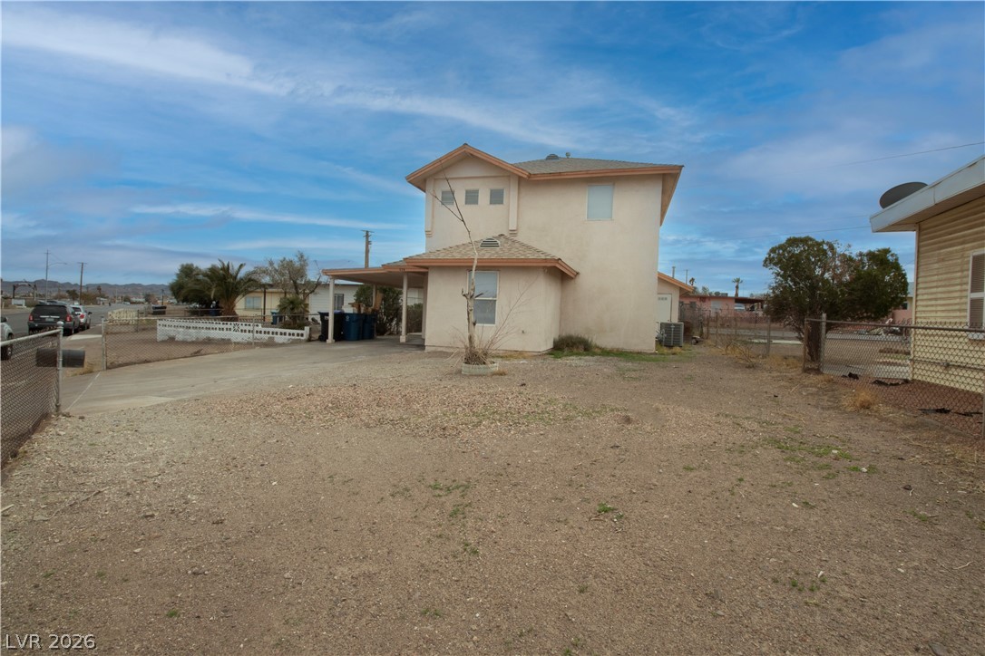 119 West Victory Road Henderson, NV 89015 - Photo 25 of 26 A spacious gravel lot provides ample parking, complementing this two-story desert abode.