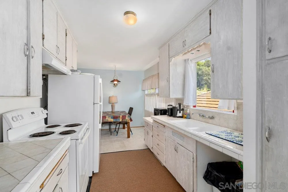 6109 Waverly Avenue La Jolla, CA 92037 - Photo 11 of 23 a kitchen with a sink stove and cabinets