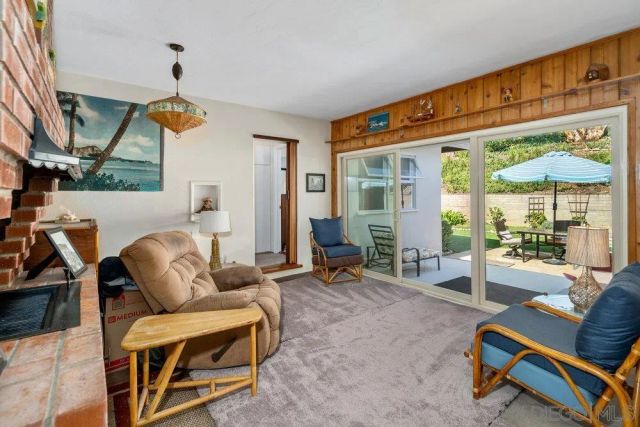 a living room with furniture a floor to ceiling window and floor to ceiling windows