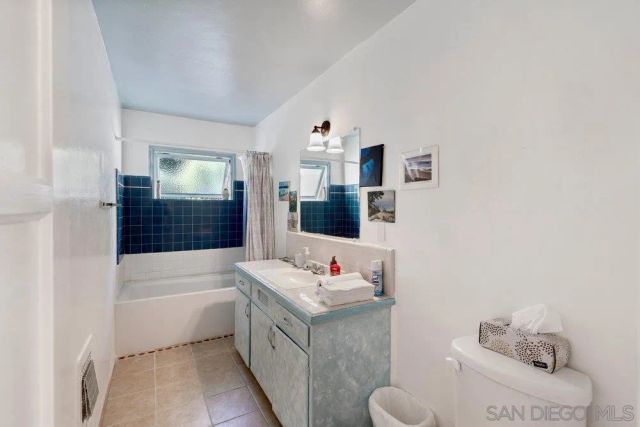 a bathroom with a tub sink and toilet