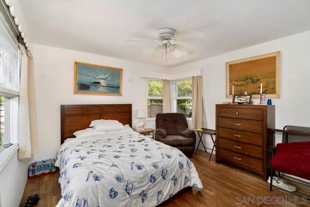 6109 Waverly Avenue La Jolla, CA 92037 - Photo 22 of 23 a bedroom with a bed and wooden floor