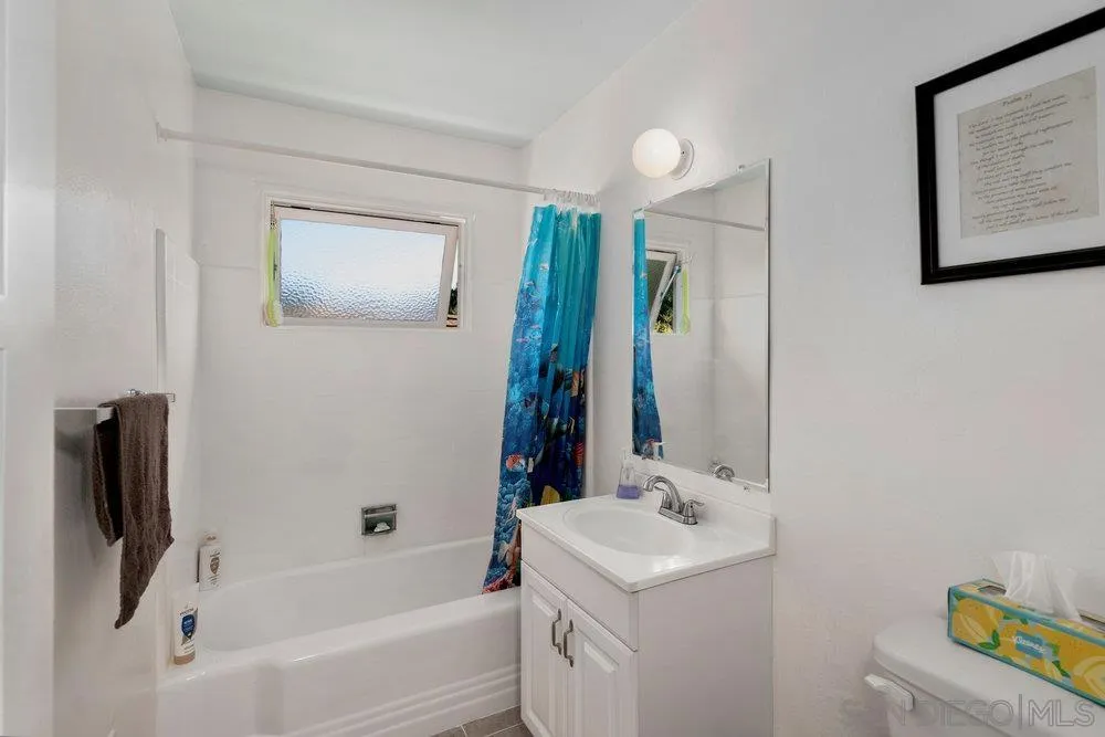 6109 Waverly Avenue La Jolla, CA 92037 - Photo 23 of 23 a bathroom with a bathtub a sink and a mirror