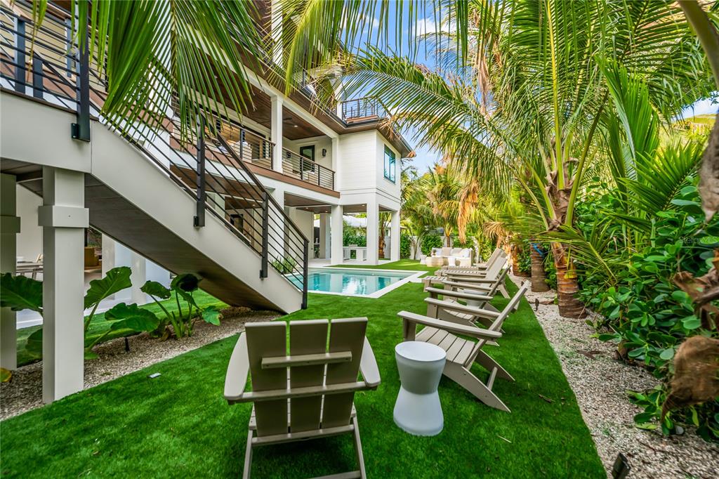 107 Maple Avenue Anna Maria, FL 34216 - Photo 11 of 68 a front view of a house with a yard and staircase