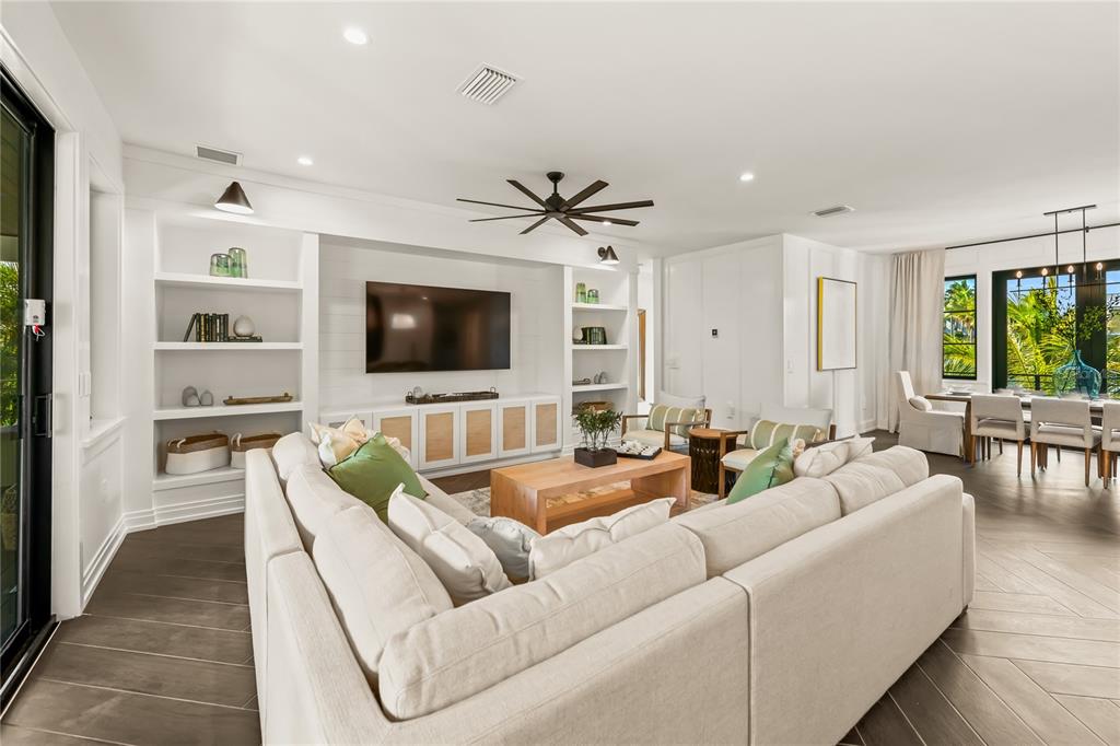 107 Maple Avenue Anna Maria, FL 34216 - Photo 28 of 68 a living room with furniture and a flat screen tv
