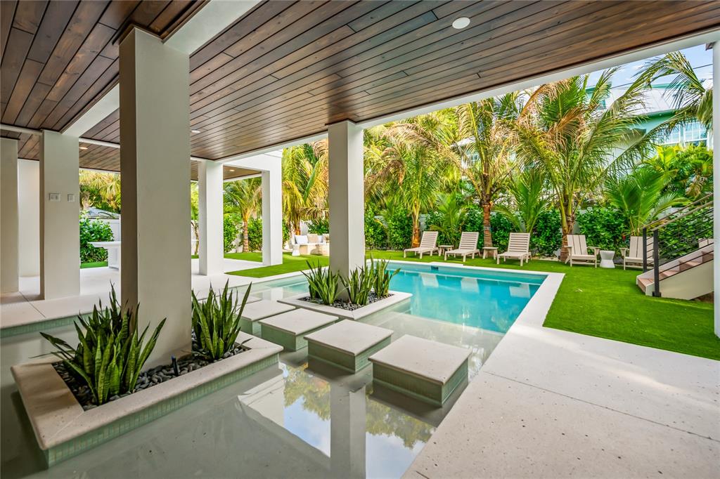 107 Maple Avenue Anna Maria, FL 34216 - Photo 4 of 68 a view of patio with swimming pool table and chairs