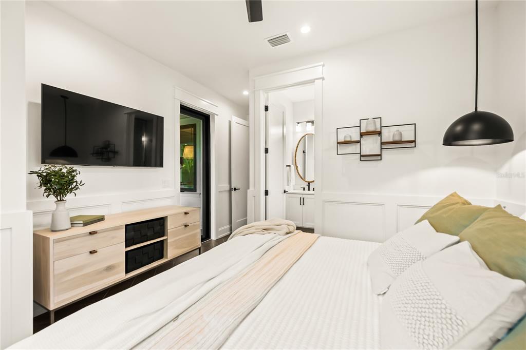 107 Maple Avenue Anna Maria, FL 34216 - Photo 46 of 68 a bedroom with a bed and flat screen tv