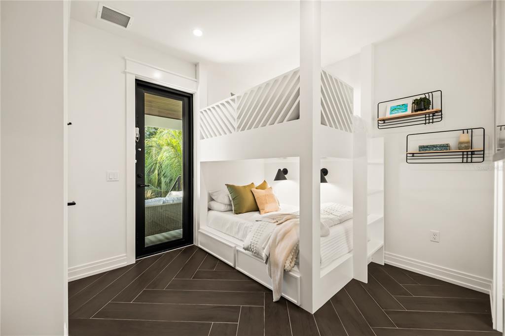 107 Maple Avenue Anna Maria, FL 34216 - Photo 48 of 68 a bedroom with a bed and a window