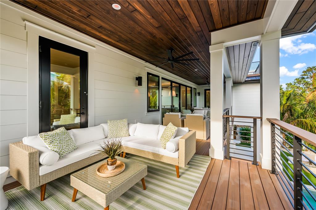 107 Maple Avenue Anna Maria, FL 34216 - Photo 58 of 68 a outdoor living space with furniture and wooden floor