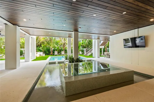 a view of an house with backyard porch and sitting area