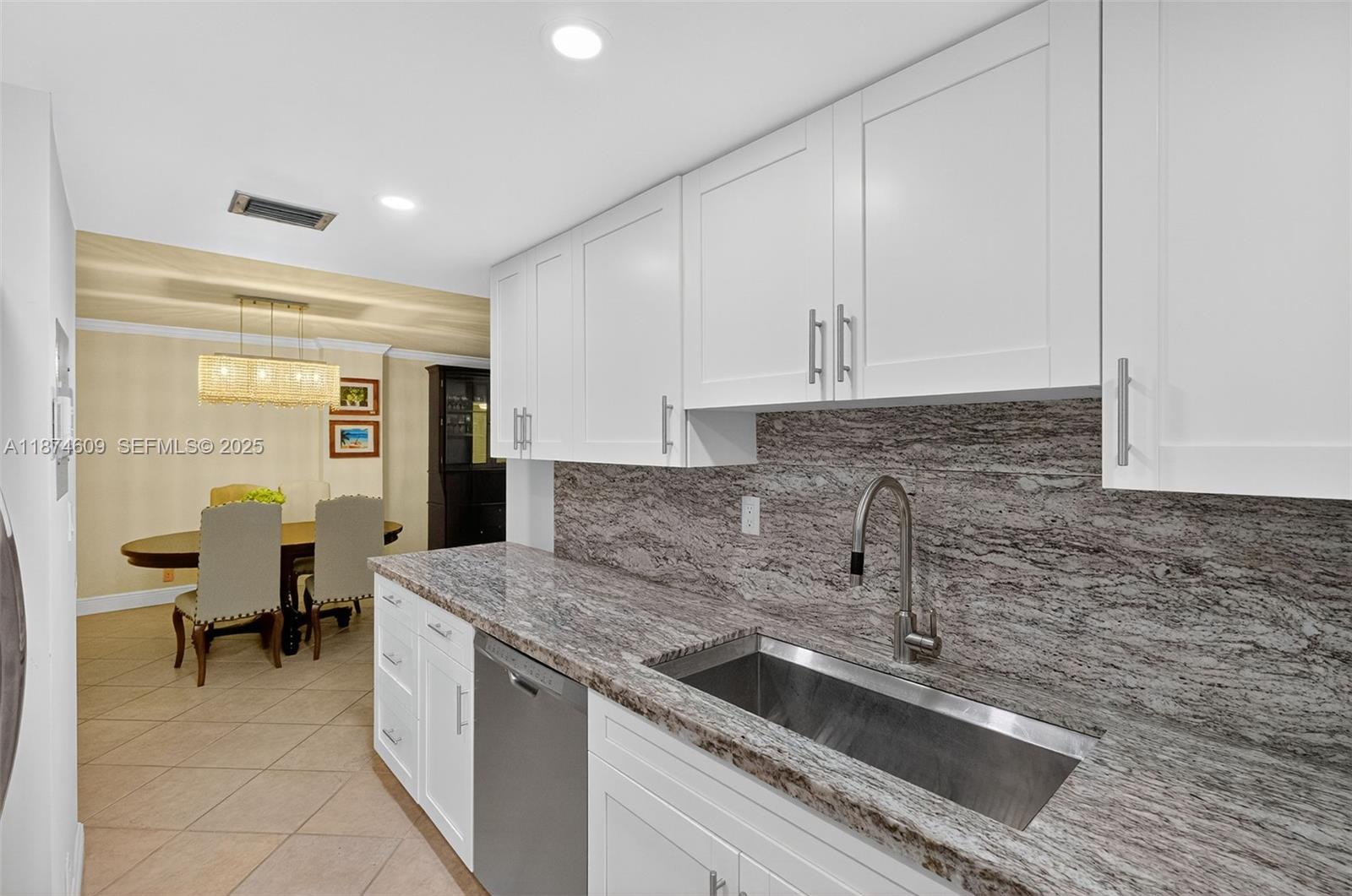2401 Collins Avenue, Unit 1005 Miami Beach, FL 33140 - Photo 6 of 19 a kitchen that has a sink and a stove in it