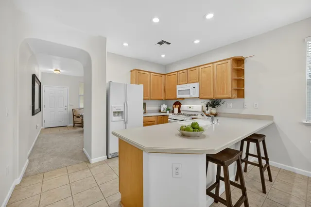 a kitchen with stainless steel appliances granite countertop a sink and cabinets
