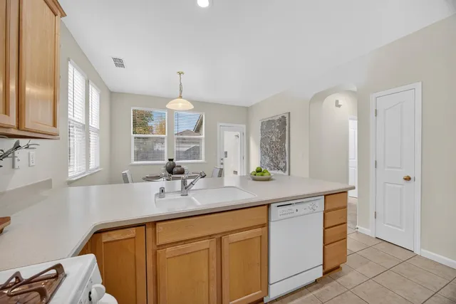 a kitchen with a sink stove top oven and cabinets