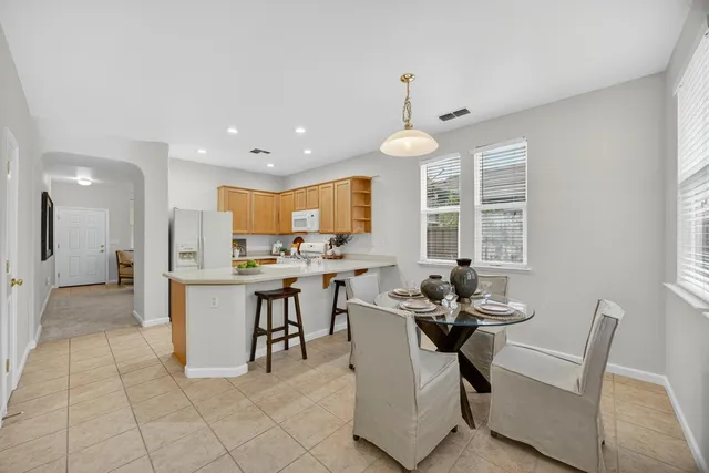 a kitchen with a dining table and chairs