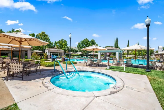 a swimming pool with outdoor seating and yard