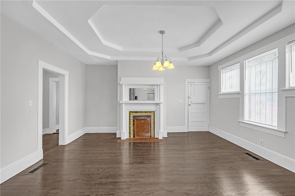 660 Queen Street Southwest, Unit B Atlanta, GA 30310 - Photo 11 of 51 an empty room with wooden floor fireplace and windows