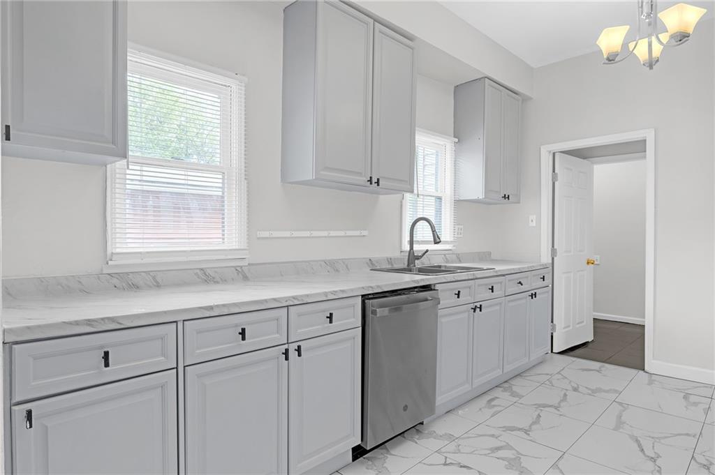 660 Queen Street Southwest, Unit B Atlanta, GA 30310 - Photo 14 of 51 a kitchen with white cabinets and sink