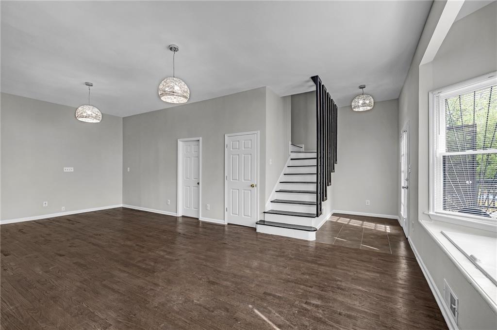 660 Queen Street Southwest, Unit B Atlanta, GA 30310 - Photo 22 of 51 an empty room with wooden floor staircase and windows