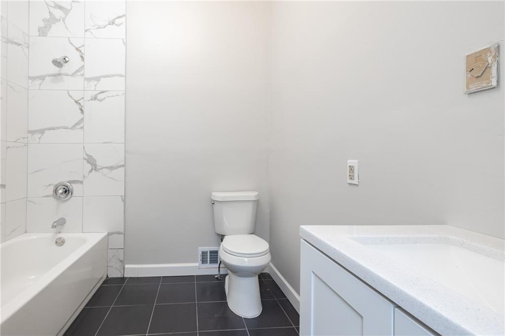 660 Queen Street Southwest, Unit B Atlanta, GA 30310 - Photo 29 of 51 a bathroom with a toilet and a bathtub