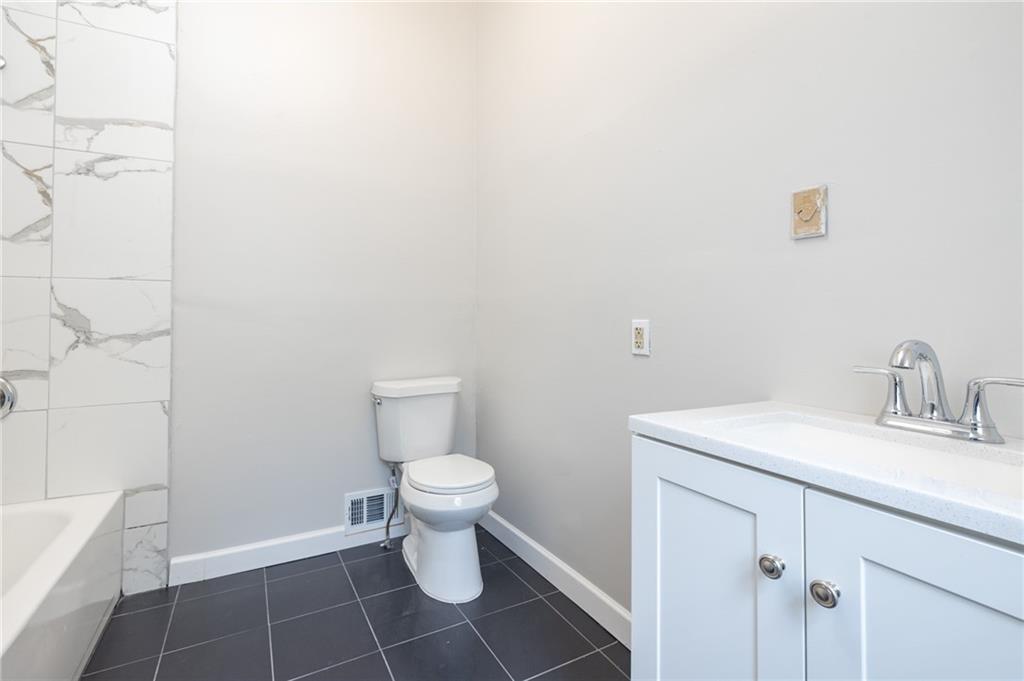 660 Queen Street Southwest, Unit B Atlanta, GA 30310 - Photo 30 of 51 a bathroom with a sink a toilet and vanity