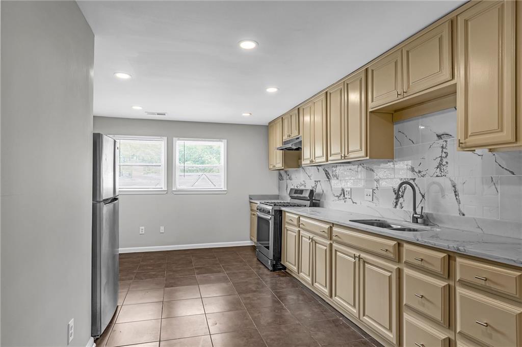 660 Queen Street Southwest, Unit B Atlanta, GA 30310 - Photo 36 of 51 a kitchen with a sink stove top oven and cabinets
