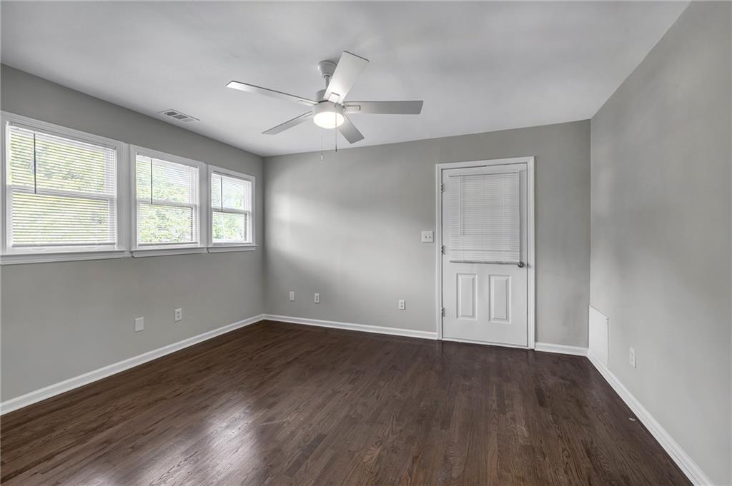 660 Queen Street Southwest, Unit B Atlanta, GA 30310 - Photo 40 of 51 an empty room with wooden floor fan and windows
