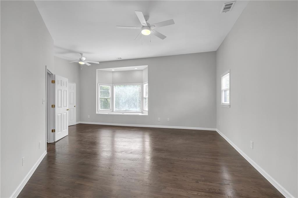 660 Queen Street Southwest, Unit B Atlanta, GA 30310 - Photo 46 of 51 an empty room with wooden floor and windows