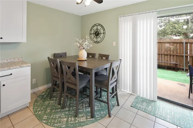 a dining room table with wooden floor and window