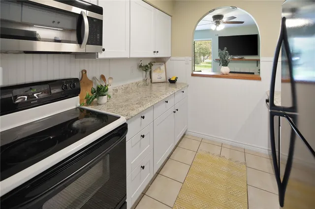 a kitchen with stainless steel appliances a sink stove and microwave