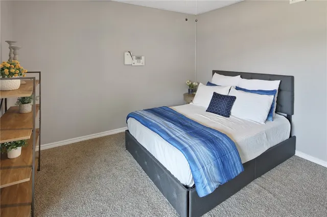 a bedroom with a bed and a mirror