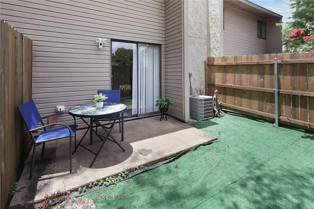 a backyard of a house with table and chairs
