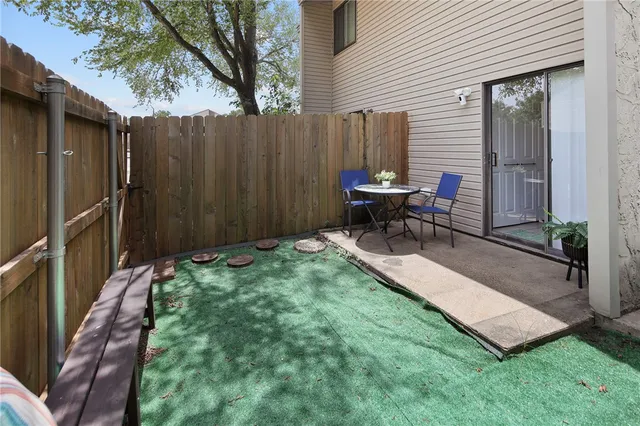 a view of a backyard with chairs