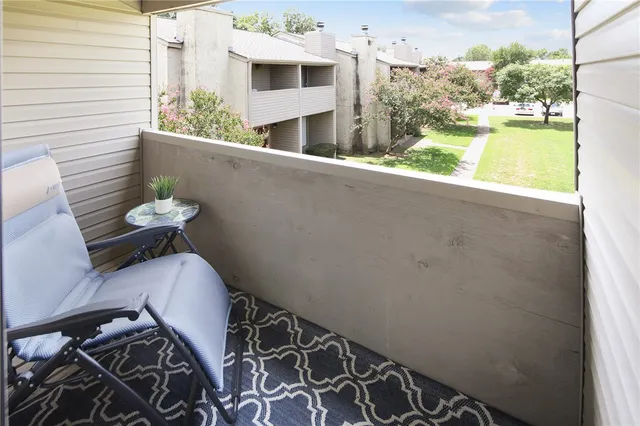 a view of balcony with furniture