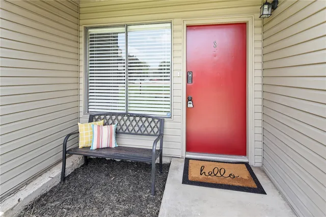 a bench sitting in front of a door