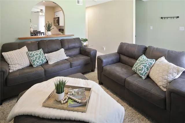 a living room with furniture and a fireplace